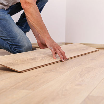 image of worker installing flooring supplied by Pacific American Lumber